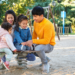 Latin family of four playing at a playground
