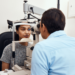 doctor performs an eye exam on patient